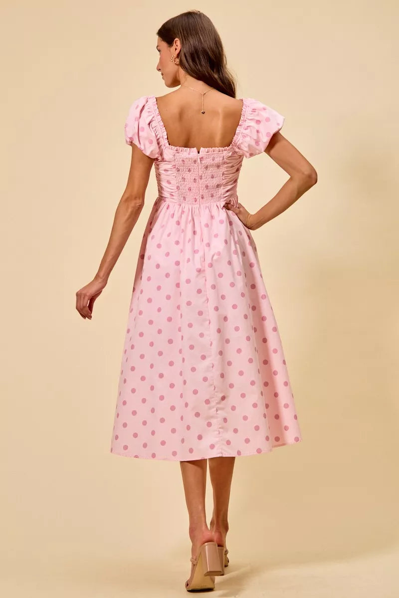 Pink polka-dot midi dress with open back, gathered square back, and puff sleeves