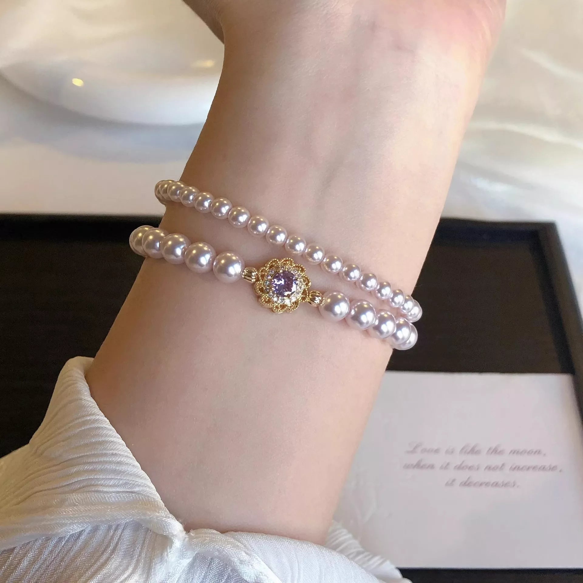18K Gold-Plated Pearl Bracelet on wrist with double pearl strands and gold flower charm