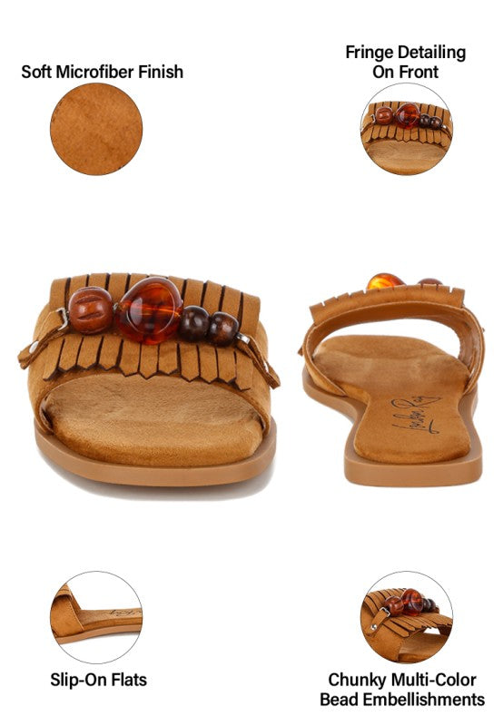 Tan microfiber slip-on flat sandals with multi-color bead straps and fringe detail