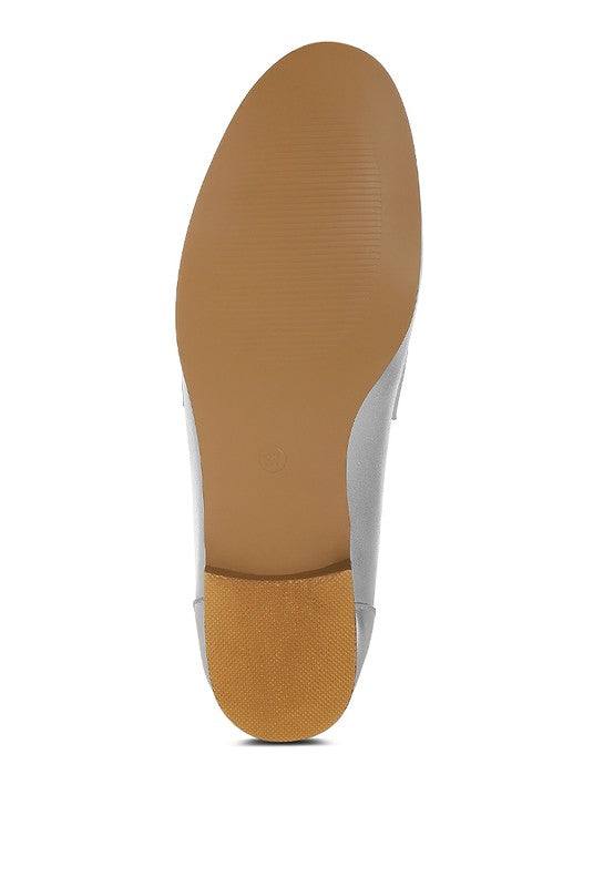 Silver metallic loafer outsole view with textured grip bottom