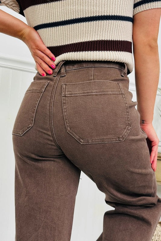 Dark brown high-rise loose jeans close-up with patch pockets and belt loops