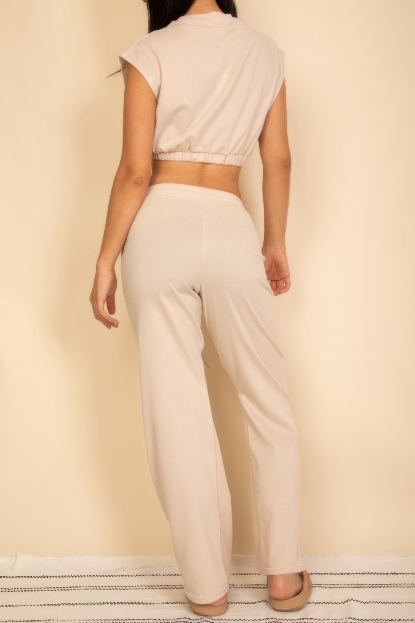 White sleeveless back view crop top and wide-leg pants, elastic waistband