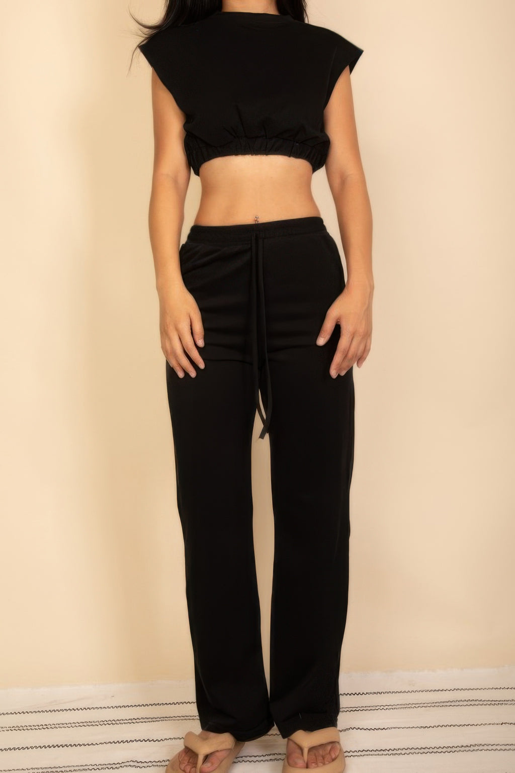 Black sleeveless crop top and wide-leg pants set with faux drawstring