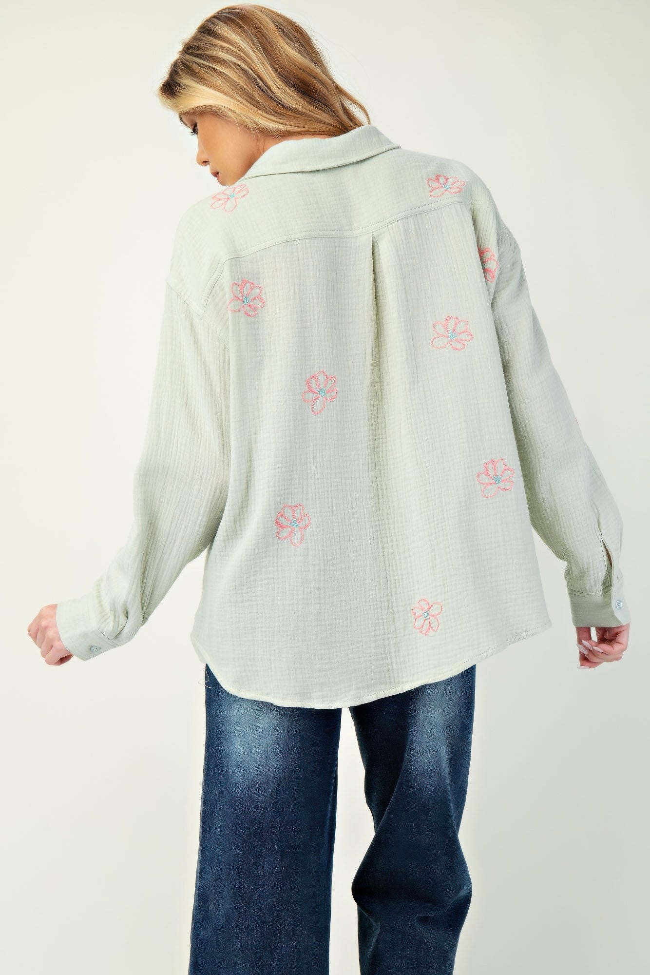 Back view: sage green cotton gauze button-down shirt with pink floral embroidery