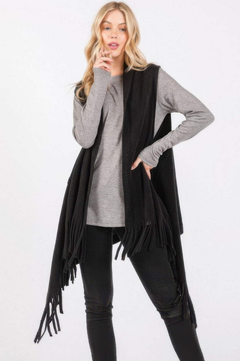 Dark black knit vest with embossed dotted line texture and tassel fringe