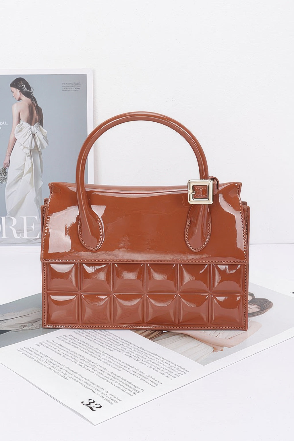 Embossed enamel top handle bag, camel-brown with gold-tone buckle clasp