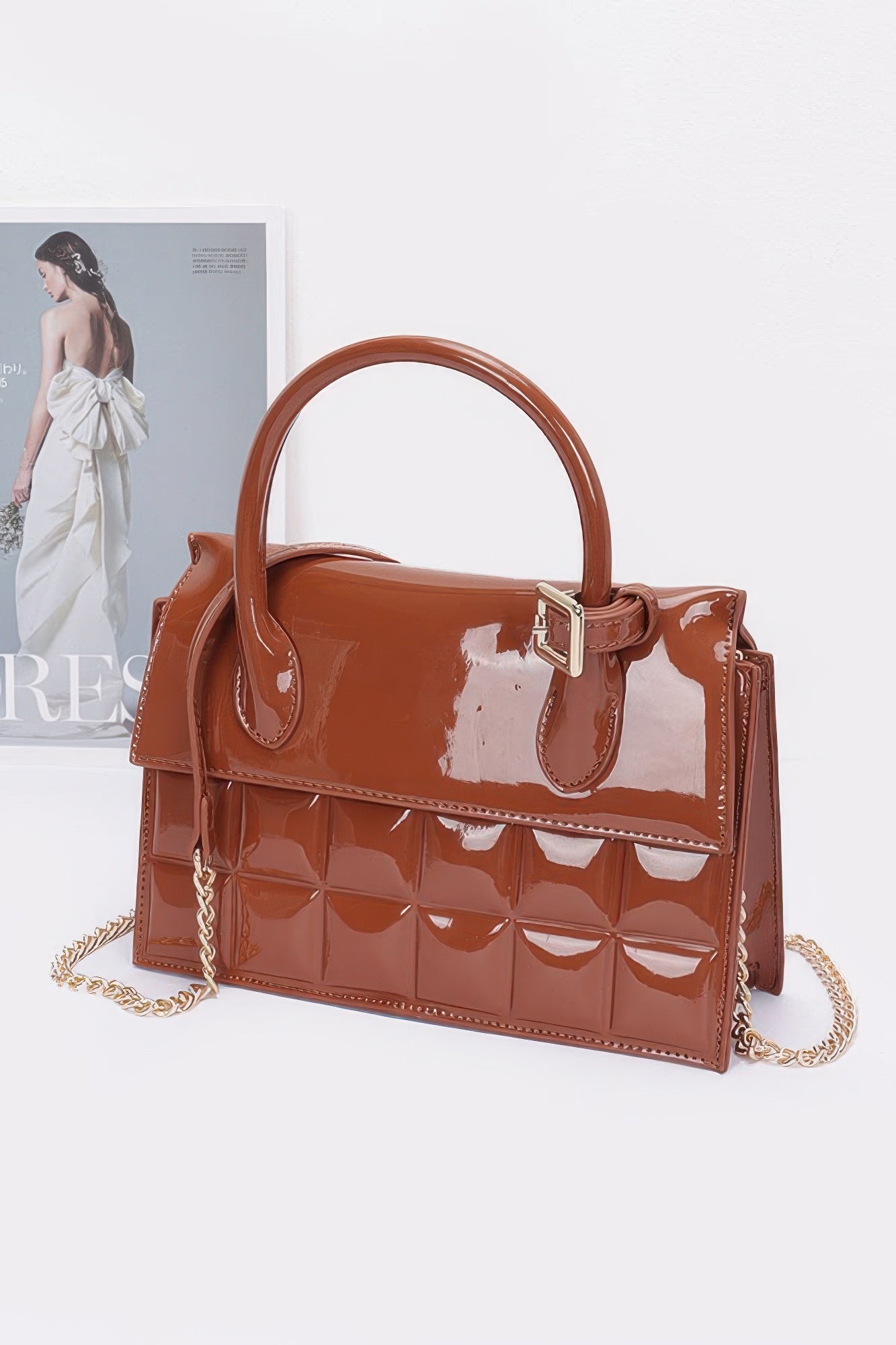 Camel embossed enamel top handle bag with chain strap and structured flap