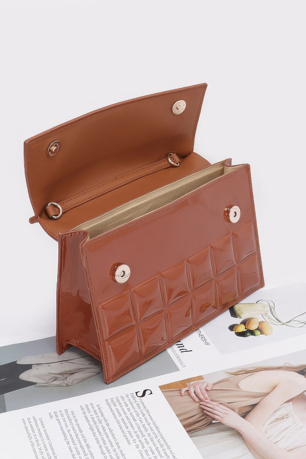 Camel embossed enamel bag open view with inner compartment and metal rings