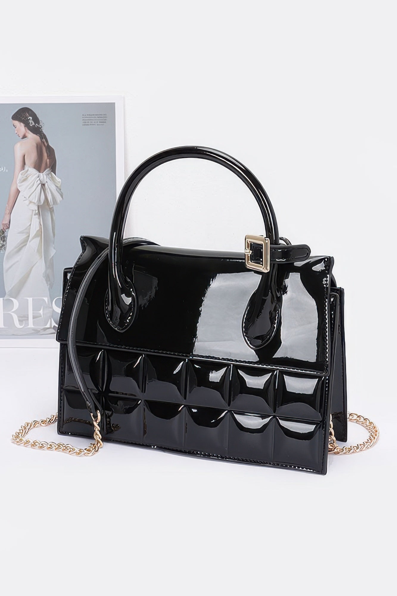 Embossed enamel top handle bag, black glossy finish with gold-tone buckle and chain