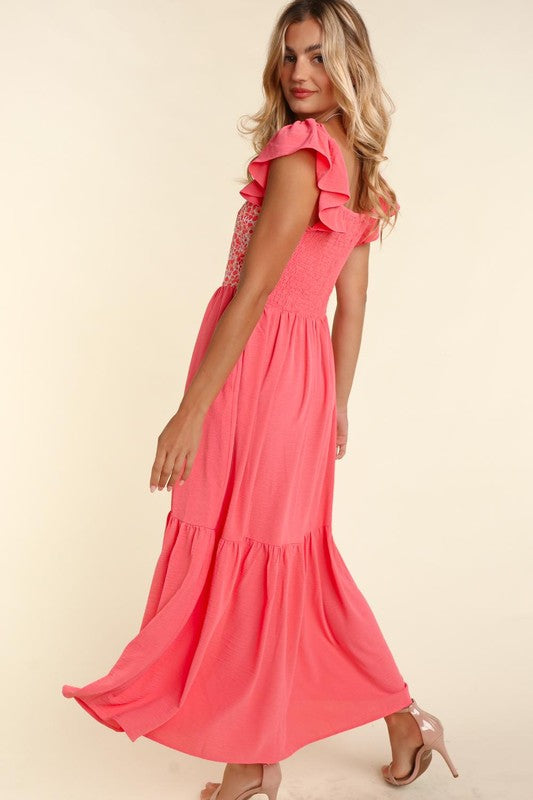 Coral maxi dress side view with embroidered dot panel, ruffled sleeves and side pockets