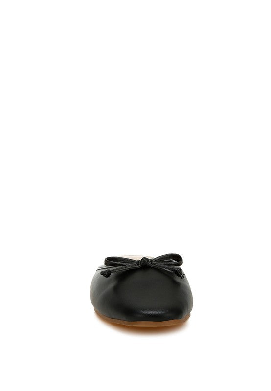 Black flat mule with tied bow at the front, low profile sole