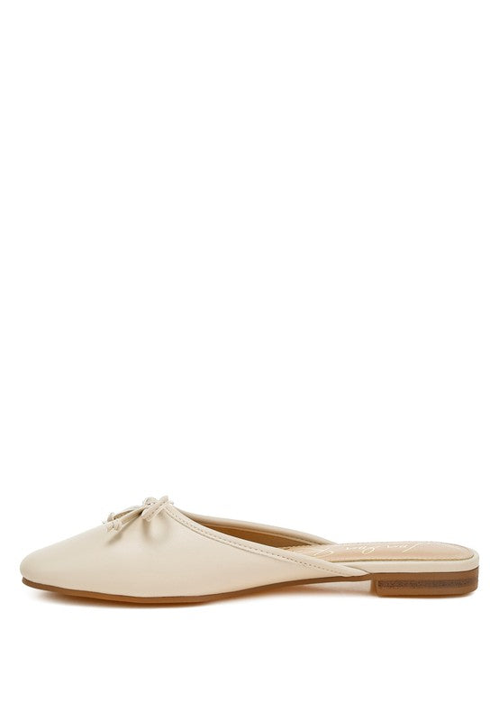Beige slip-on flat mule, side view with low brown sole