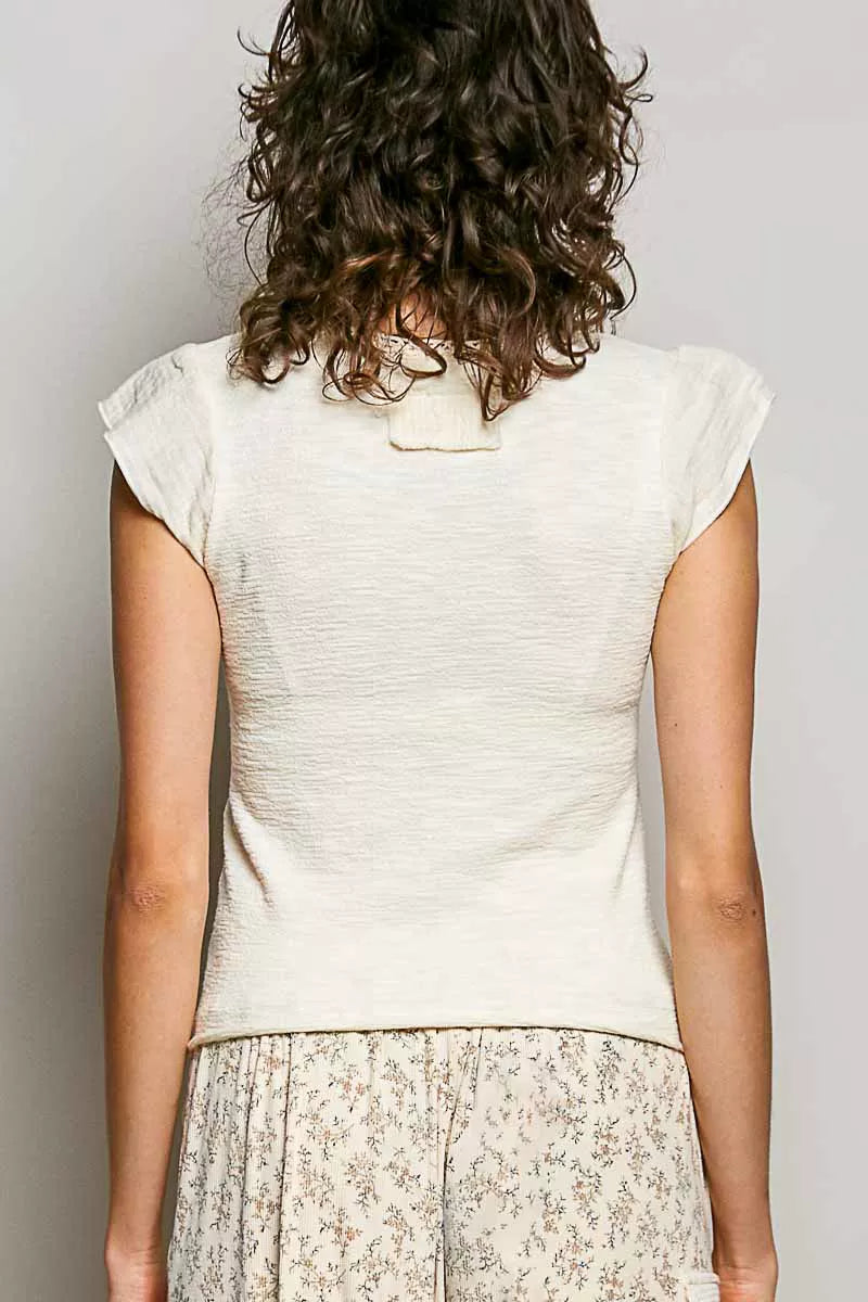 Back view: cream textured knit V-neck top with short sleeves and lace trim