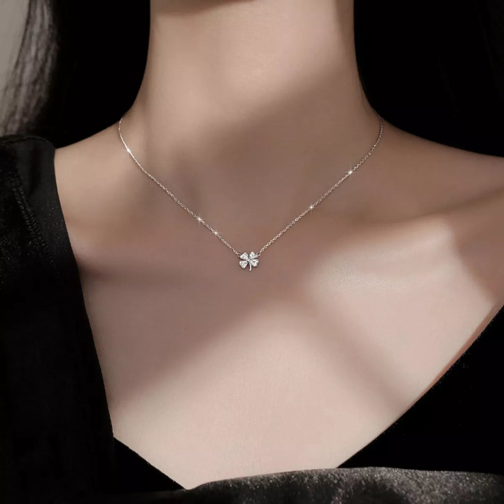 Four-leaf clover zircon necklace in silver on model's chest