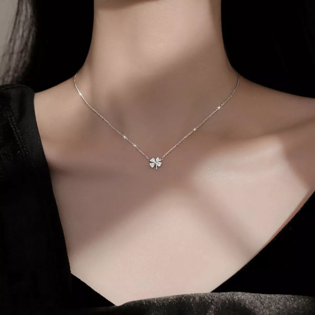Four-leaf clover zircon necklace in silver on model's chest