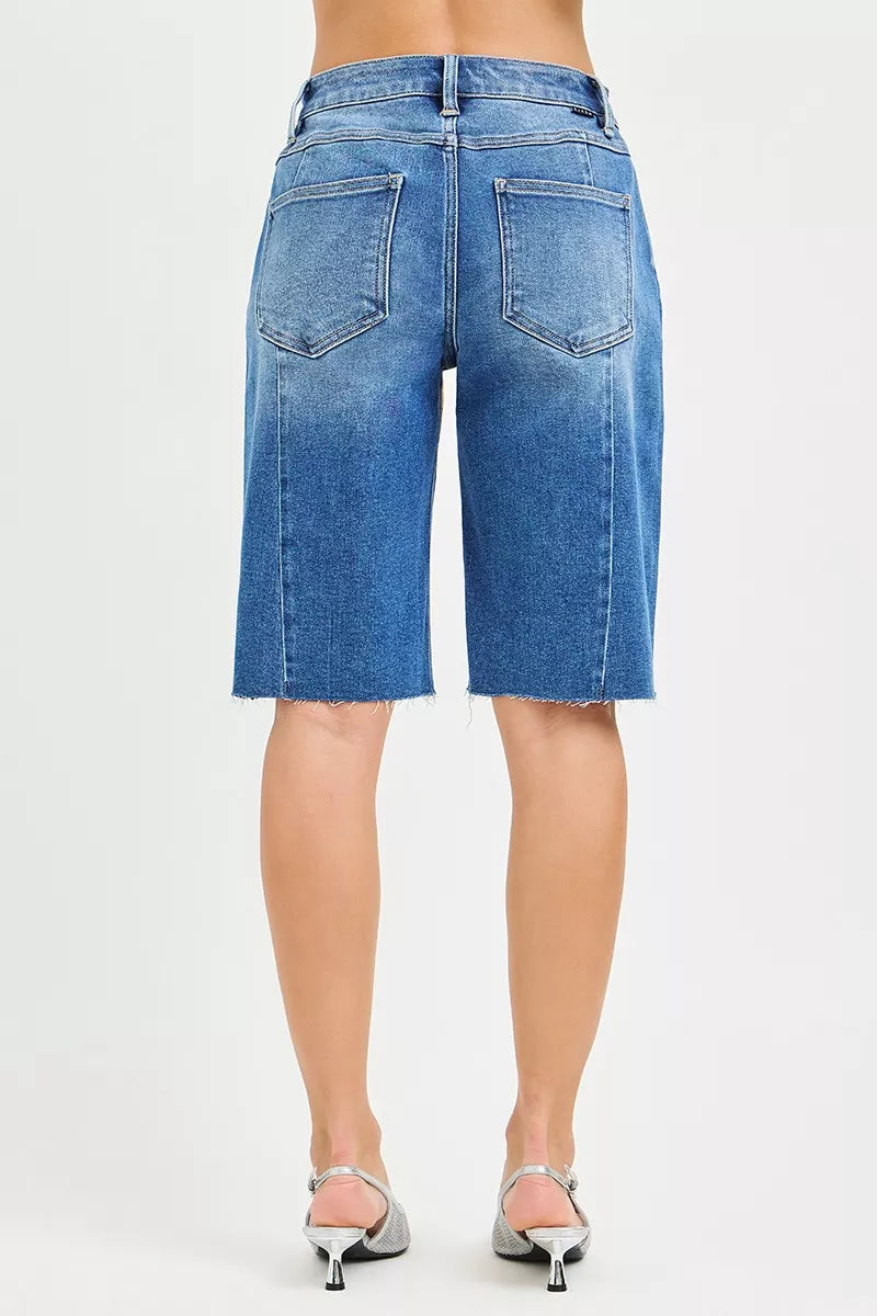 Back view slouchy seamed jorts in medium wash denim, patch pockets, raw frayed hem