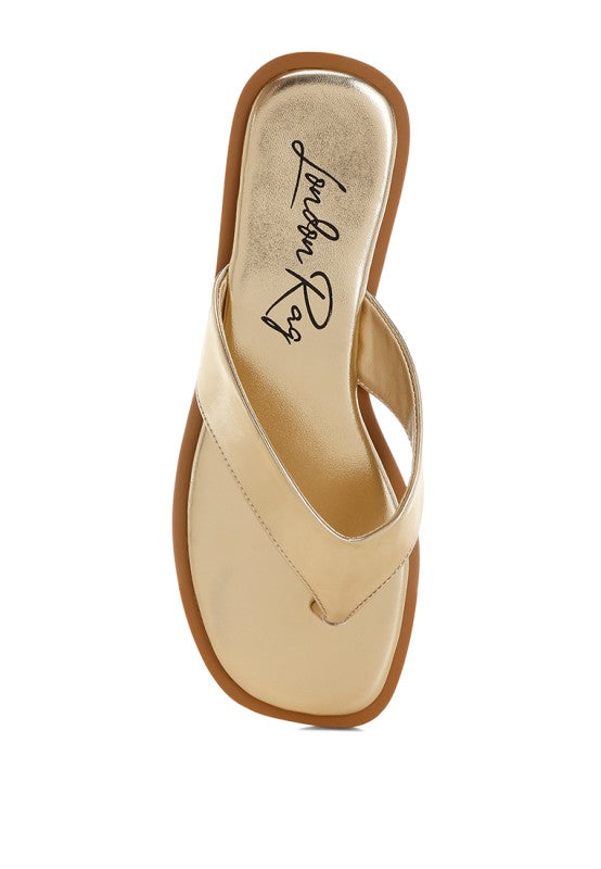 Gold metallic slide sandal showing printed insole and thong strap