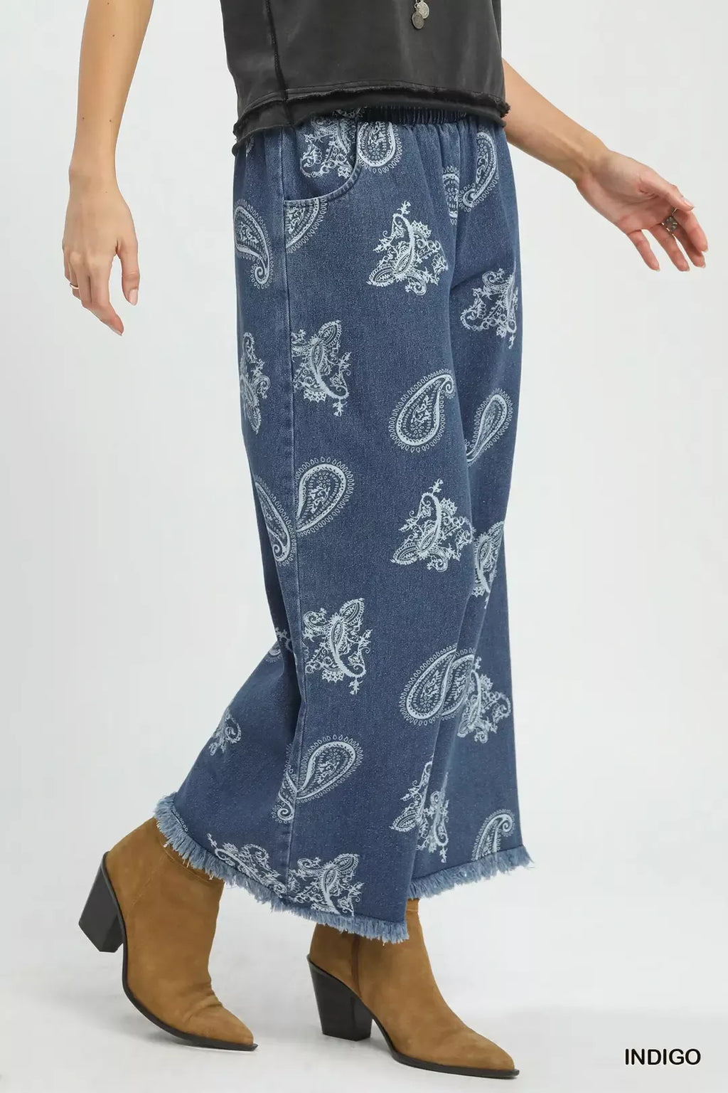 Indigo denim wide-leg pants with white paisley print and frayed, unfinished hem