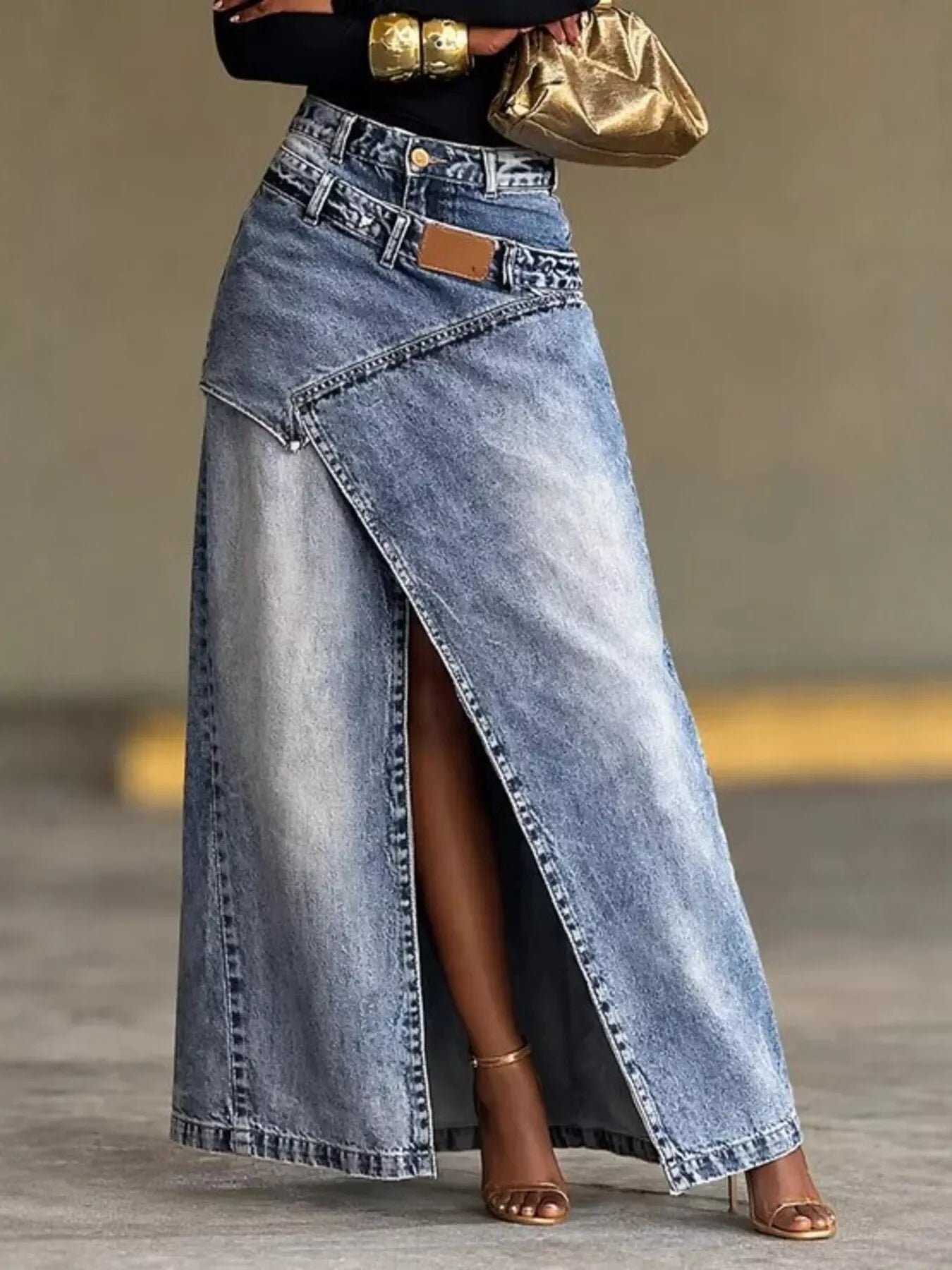 Blue high-waisted denim skirt with front slit, button front, and belt loops