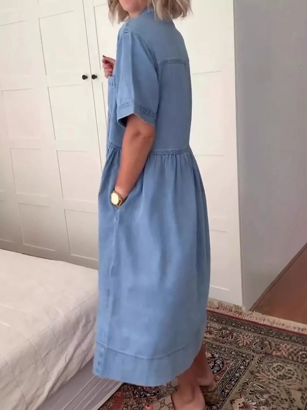 Blue denim midi dress with button front, short sleeves, and tiered skirt