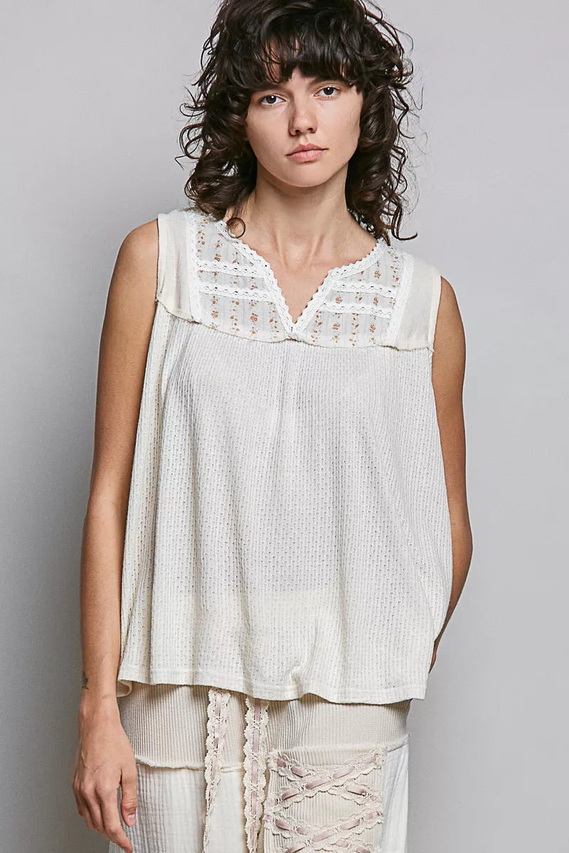 Natural sleeveless patchwork top with embroidered floral lace trim at neckline
