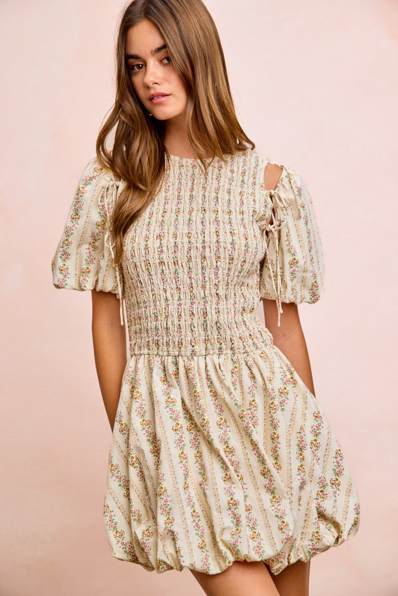 Ivory floral mini dress with smocked bodice and bow-tied shoulder cutouts