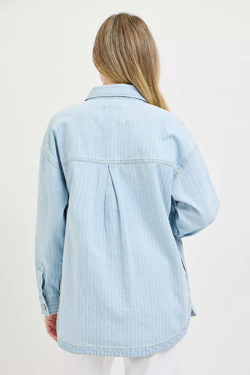Back view of light-wash oversized denim shaket with yoke seam and hemline