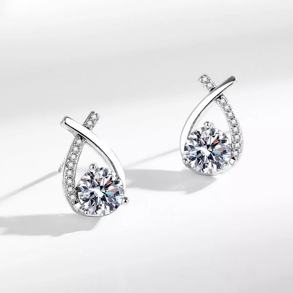 Moissanite teardrop earrings, side view, pavé frame with round center stone