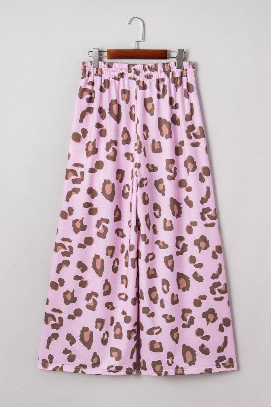 Pink leopard print high-waist pants with drawstring and wide legs on a hanger