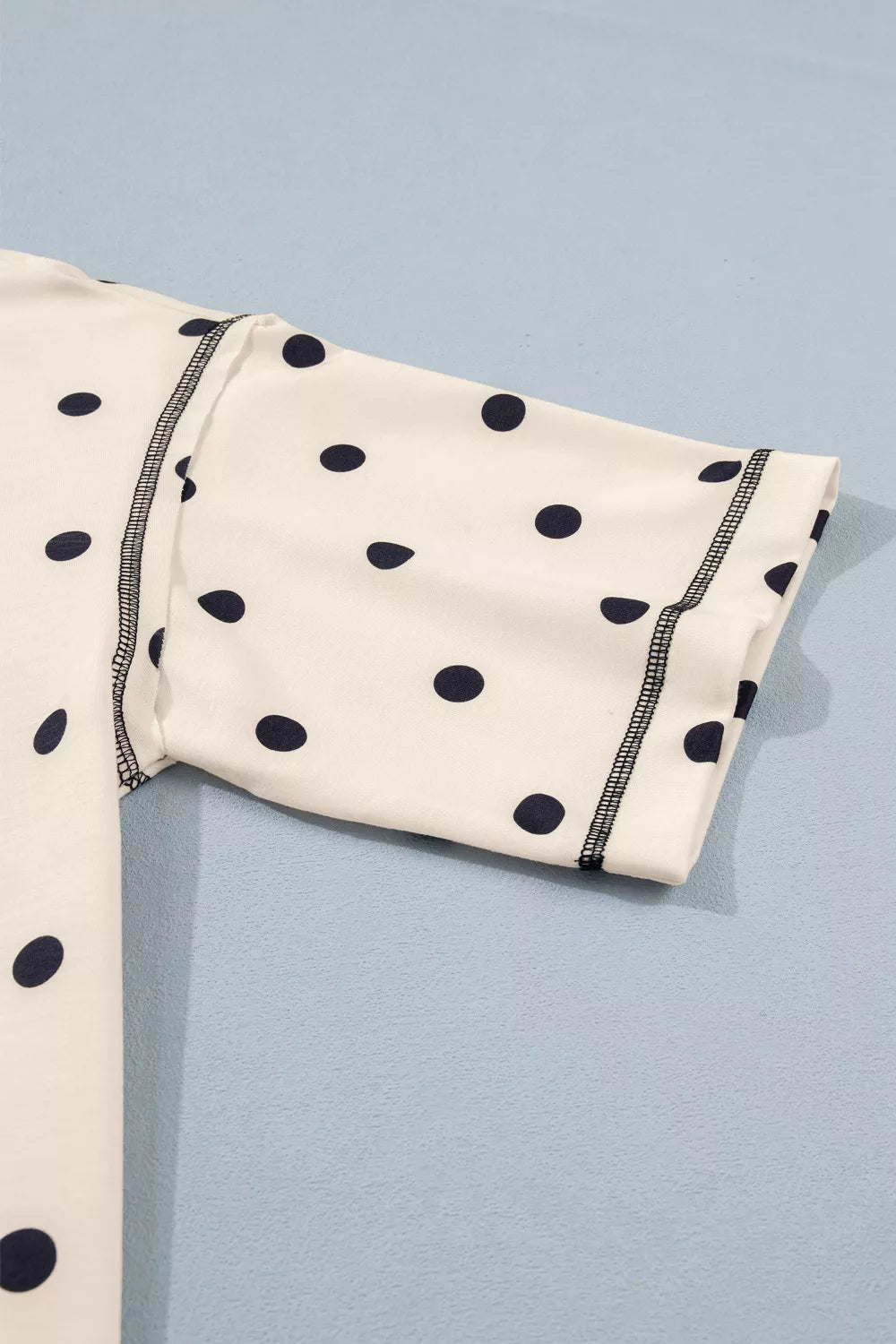 Cream short sleeve with navy polka dots and contrast striped cuff
