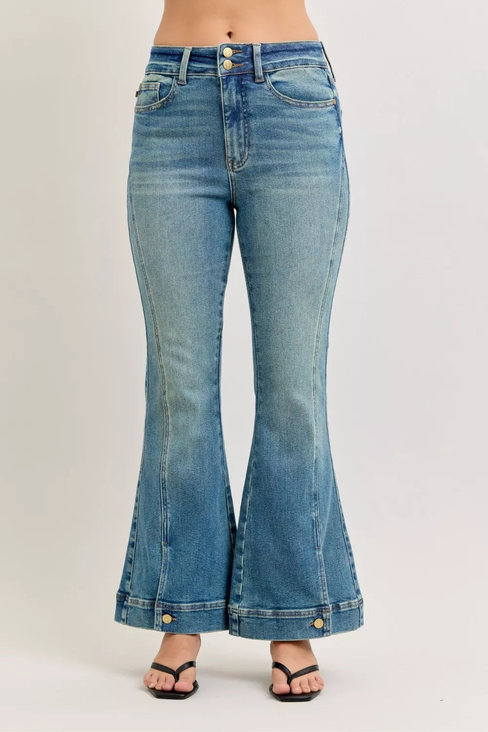 High-waist flare jeans in vintage-wash denim with front pockets and gold buttons