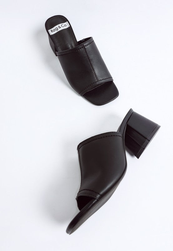 Black leather slip-on heels with open toe and thick block heel, top and side angles