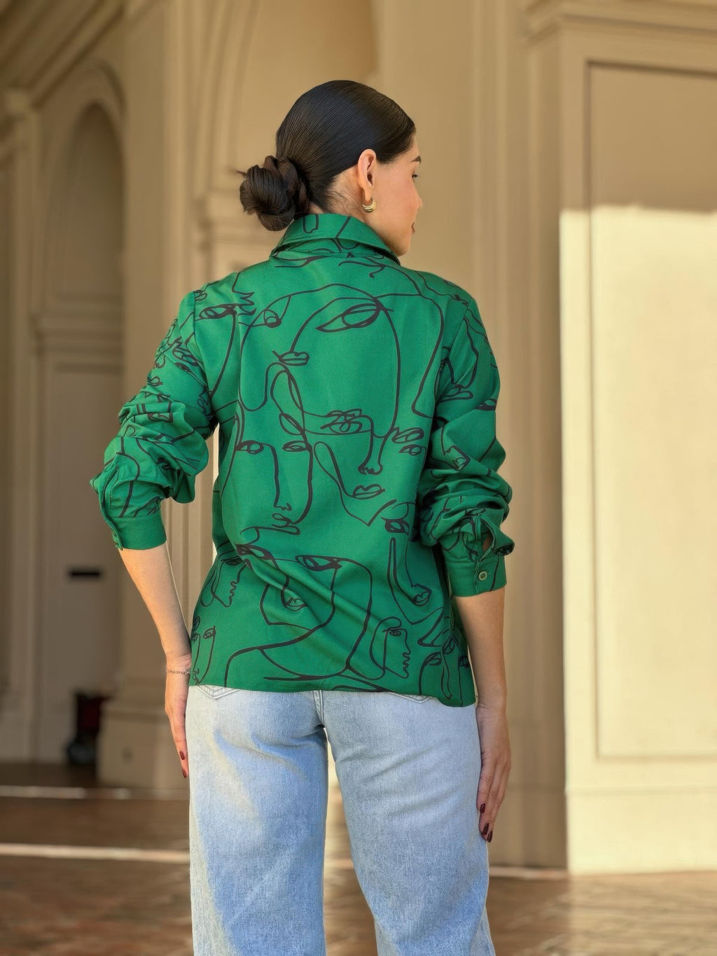 Green face-print button-down blouse back view showing centered seam and long sleeves