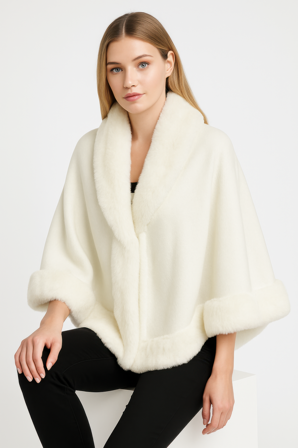 Ivory cape jacket with faux fur trim along the collar, front edge, and hem