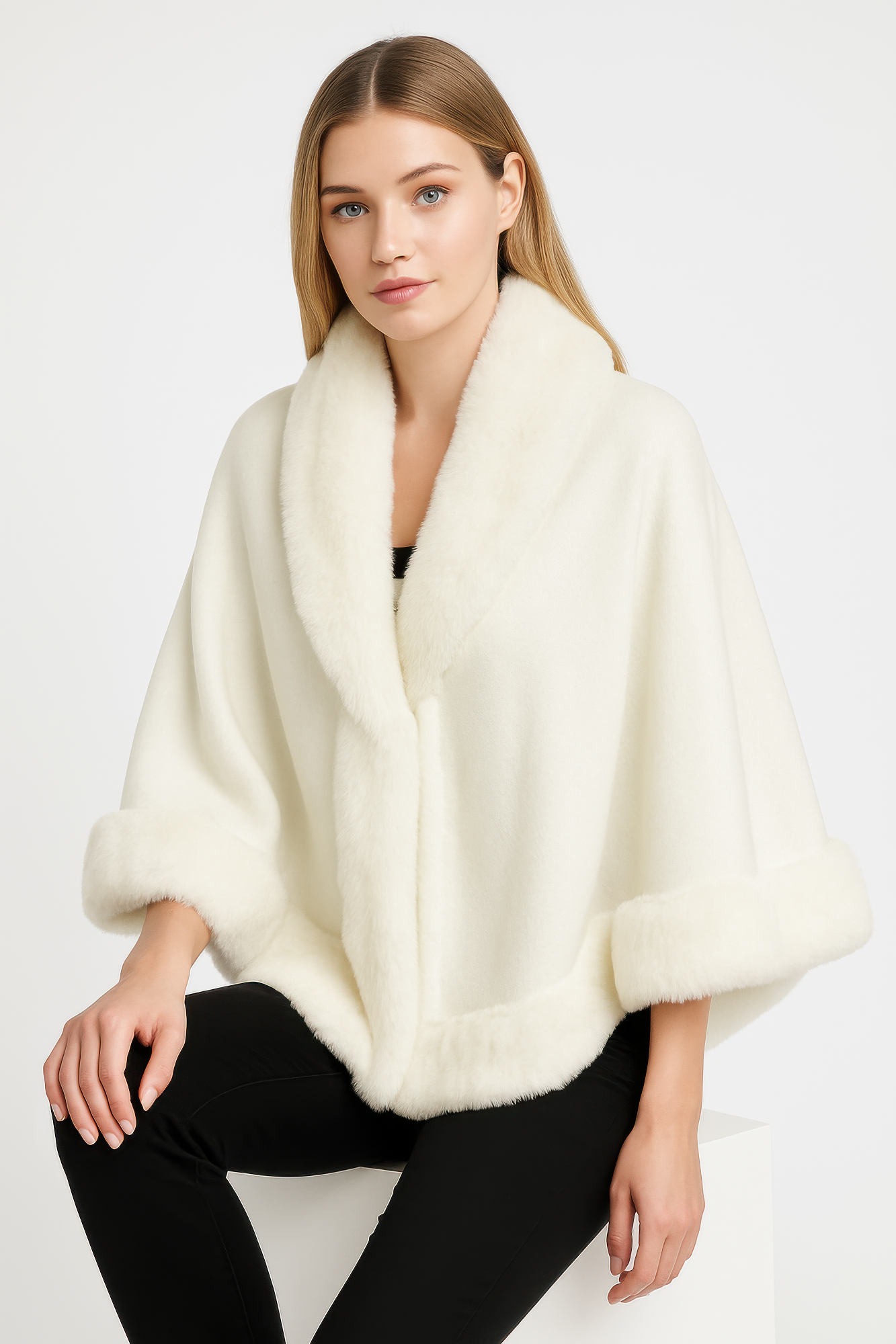 Ivory cape jacket with faux fur trim along the collar, front edge, and hem
