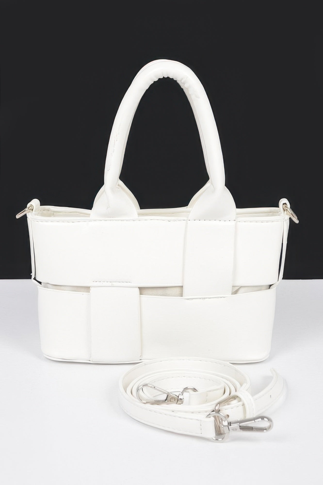 White faux leather small tote bag with braided handles and adjustable shoulder strap