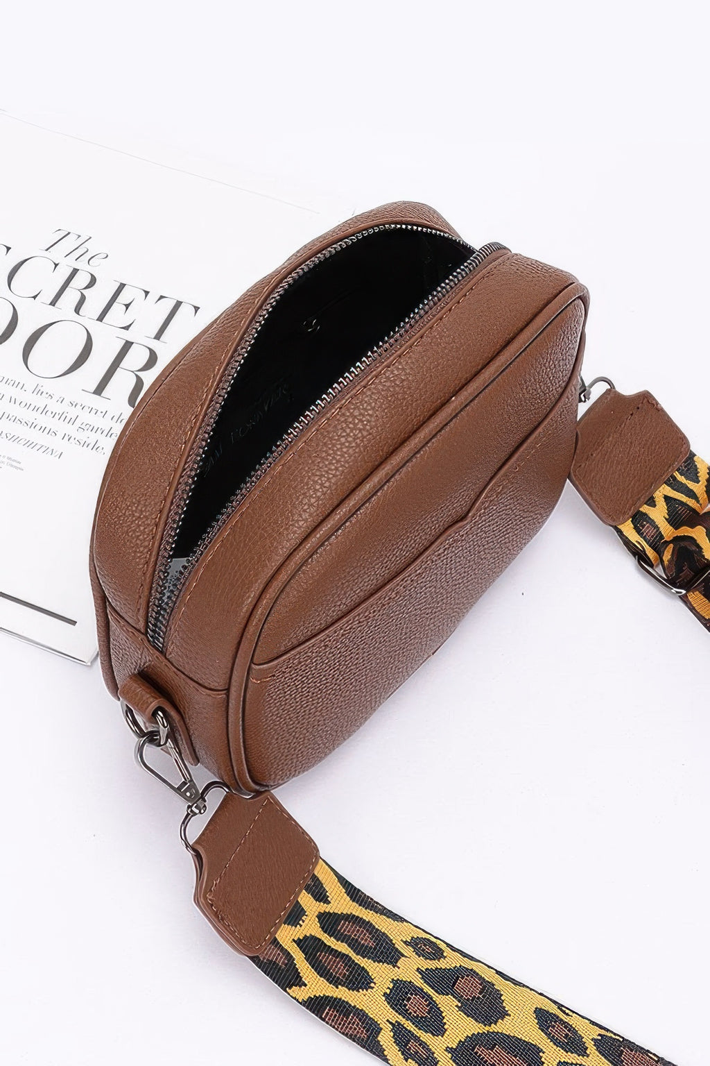 Brown faux leather camera bag open zipper, leopard strap across bottom