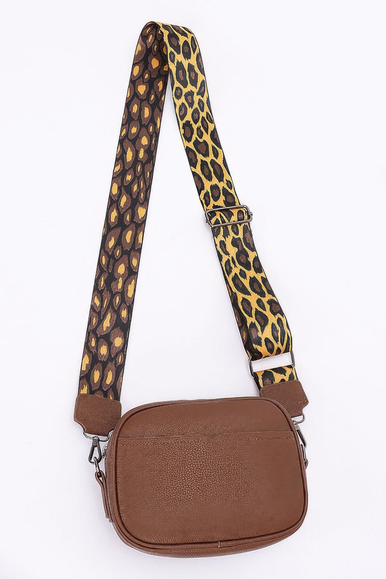 Brown camera bag with long leopard print crossbody strap and metal rings