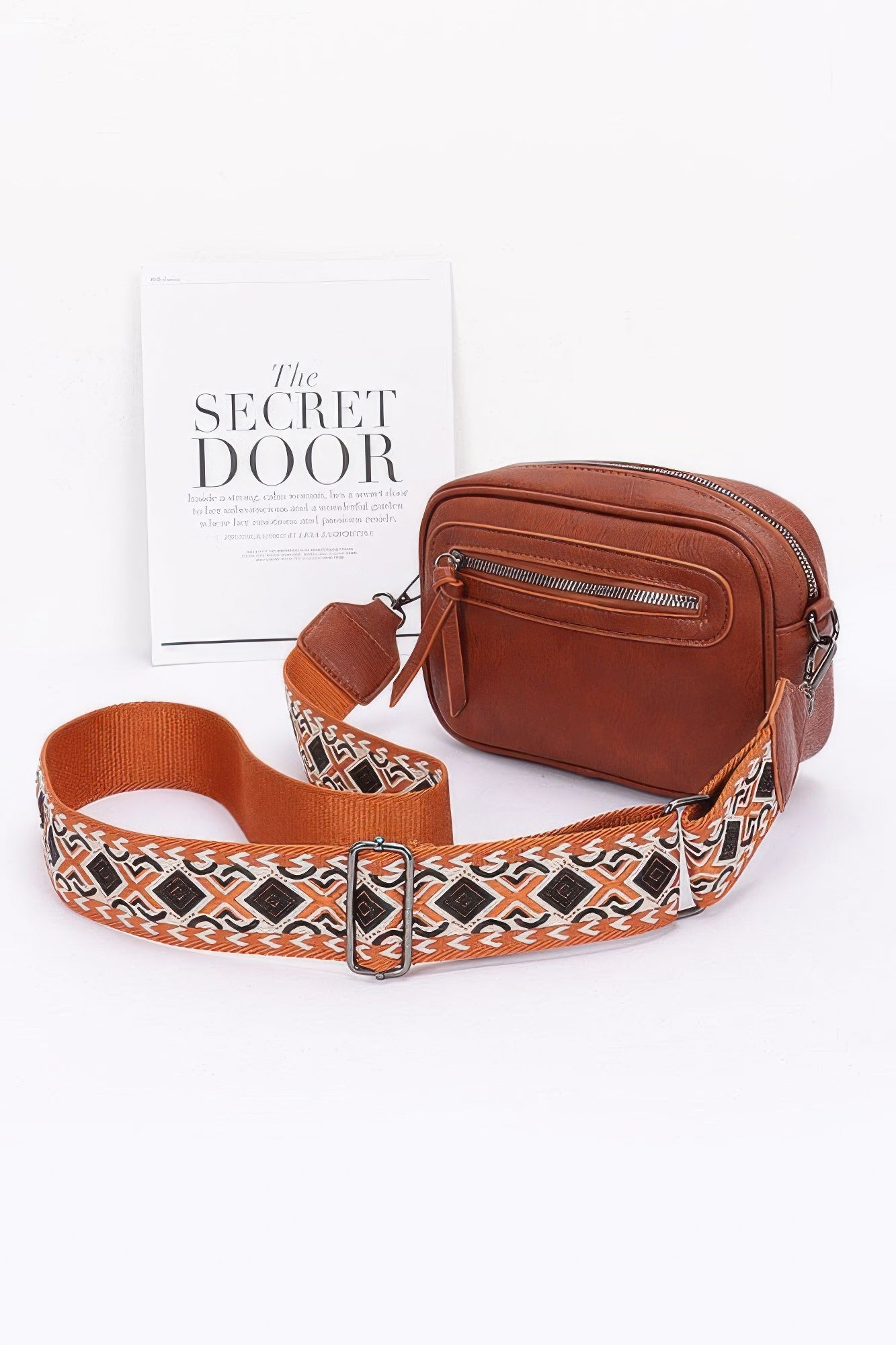 Camel faux leather camera bag with front zip pocket and patterned multicolor strap
