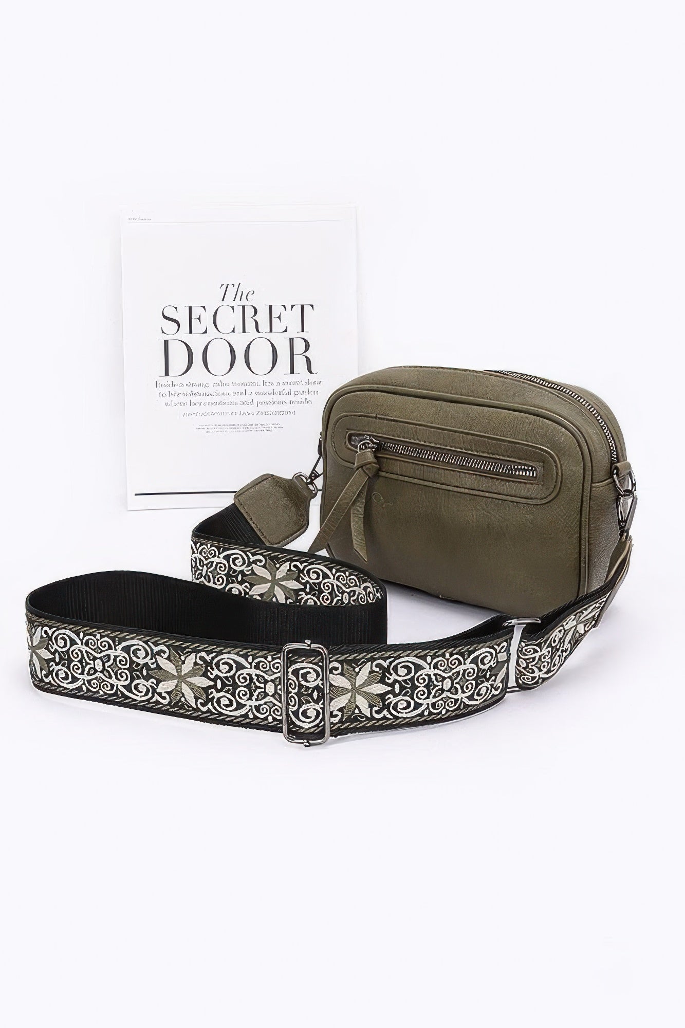 Olive faux leather camera bag with zip top and patterned strap with metal buckle