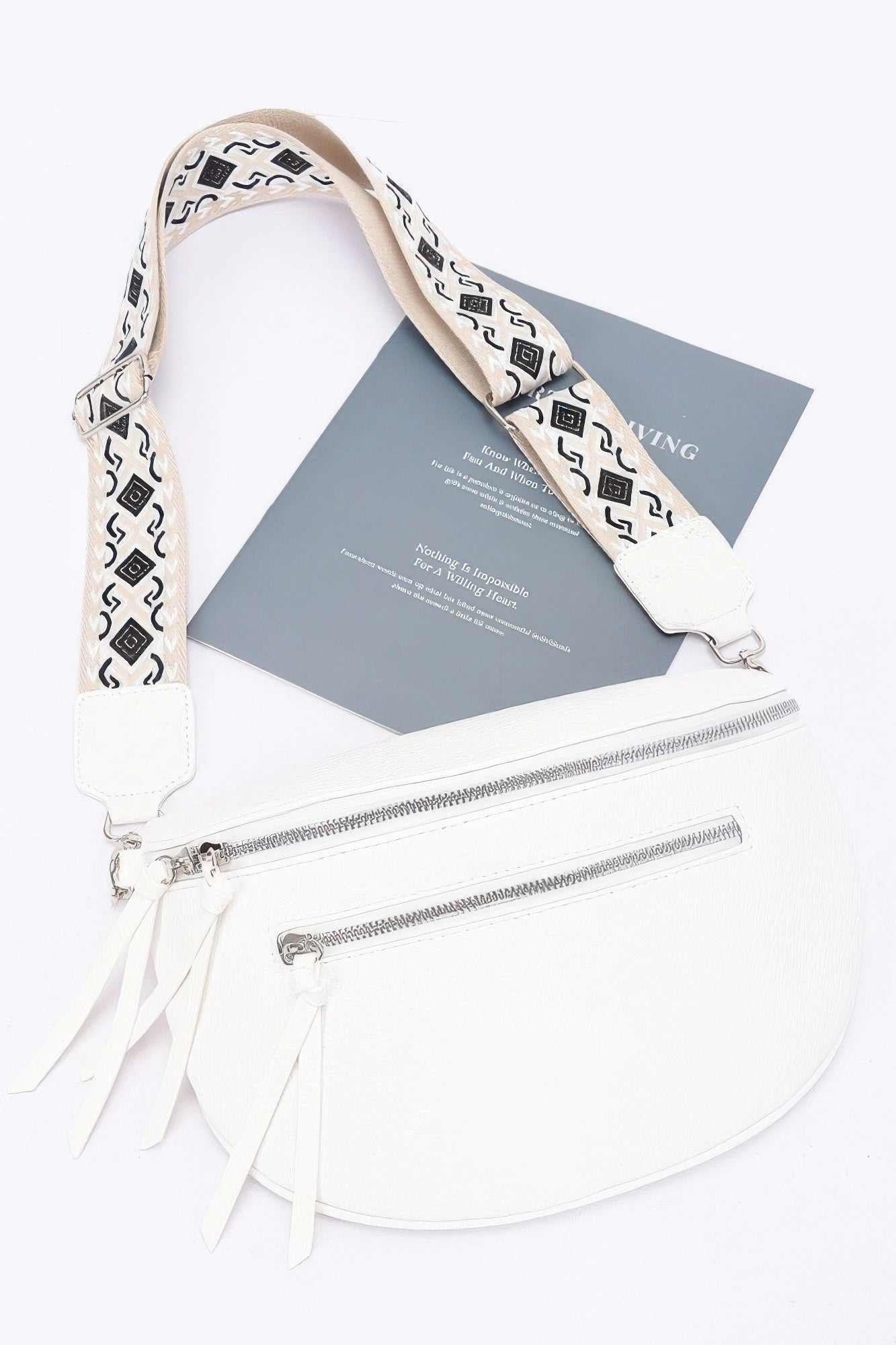 Beige faux leather crossbody belt bag with two-way zipper and tassel strap