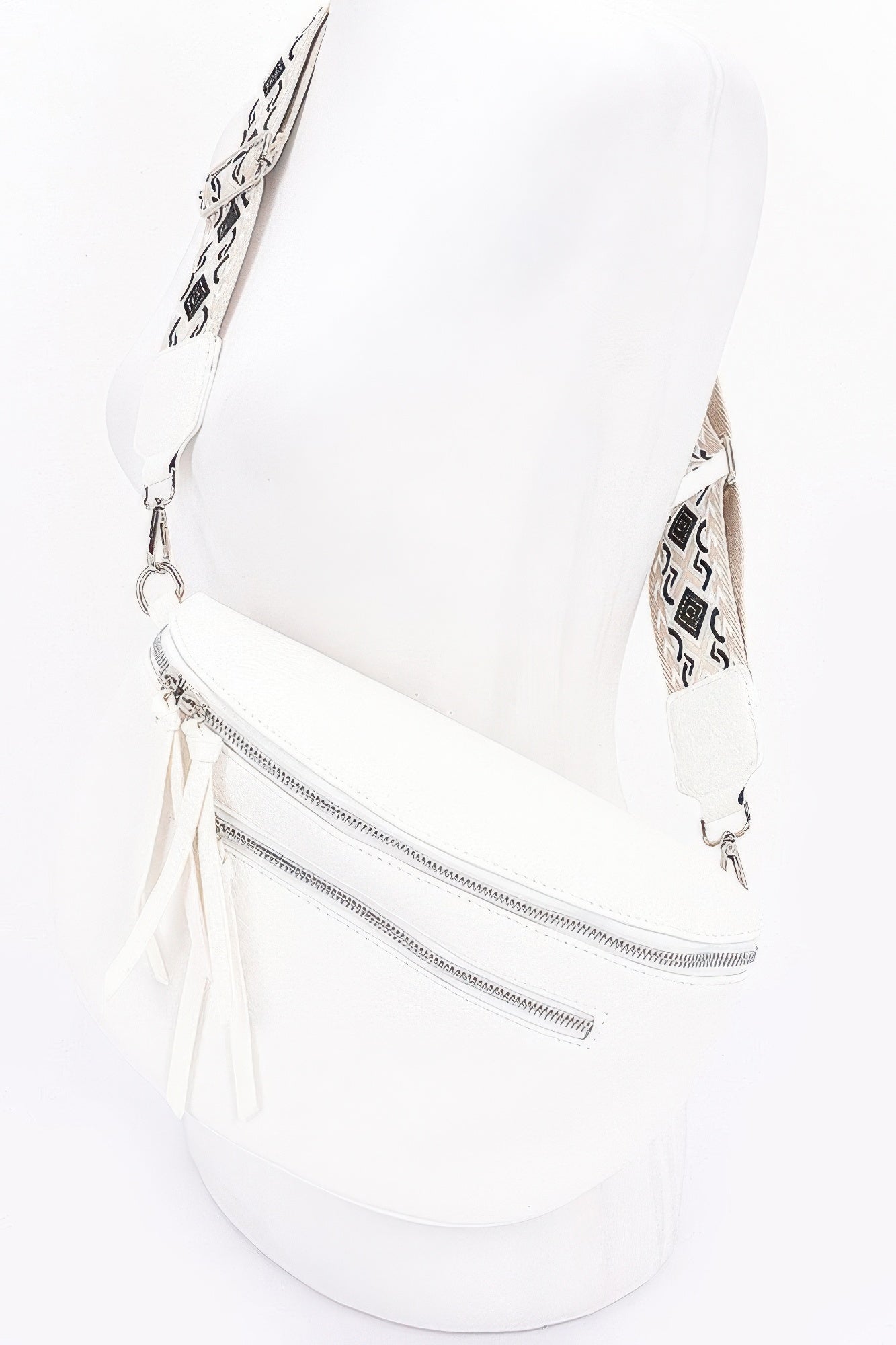 White faux leather crossbody belt bag, curved front, long strap with tassels