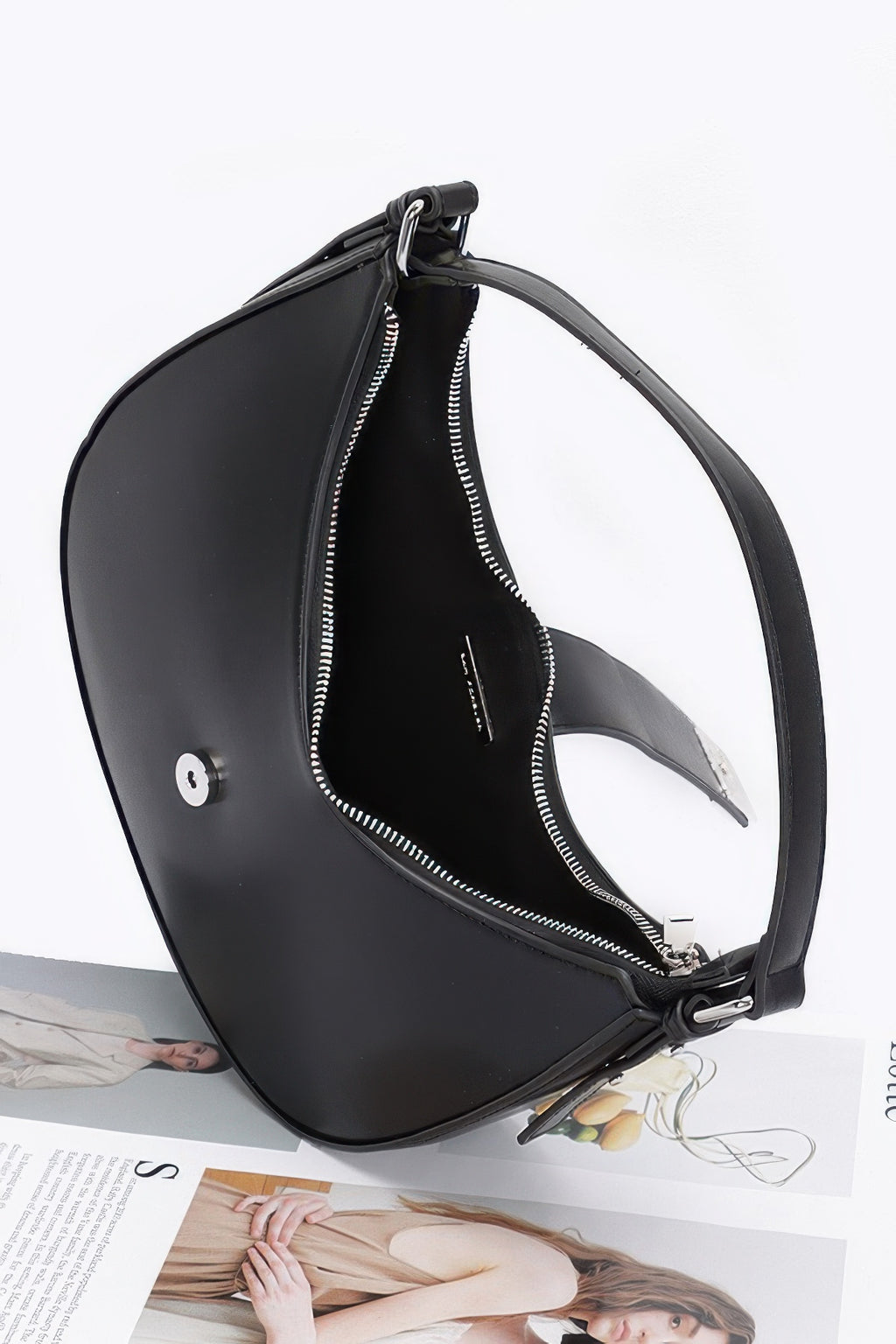 Black faux leather hobo bag open top, visible zipper lining