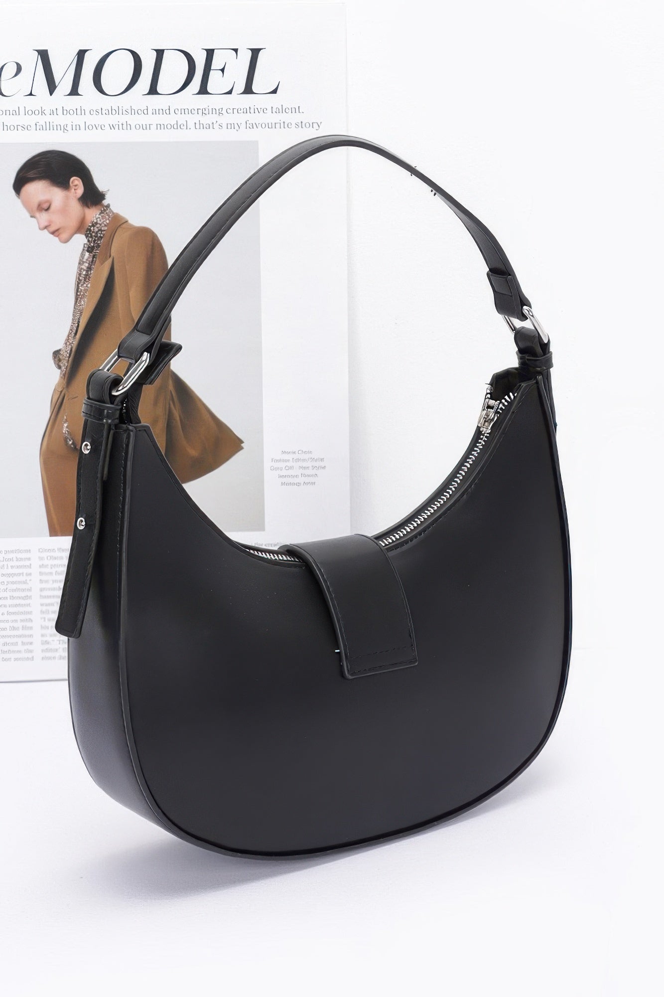 Black faux leather hobo bag front view with adjustable strap