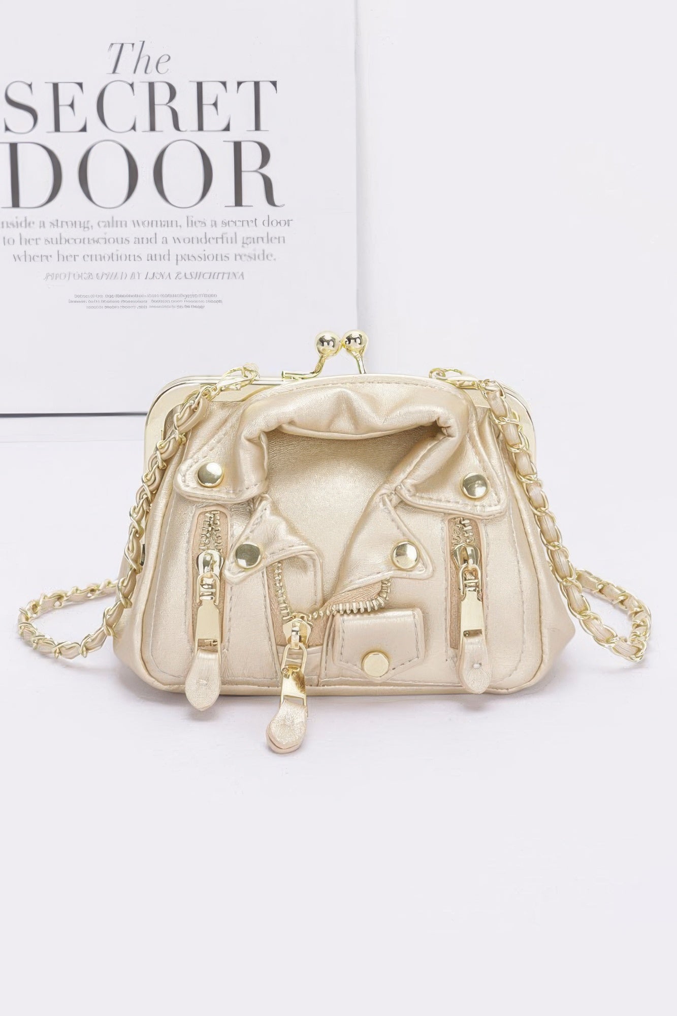 Gold faux leather crossbody bag with front zip details and chain strap