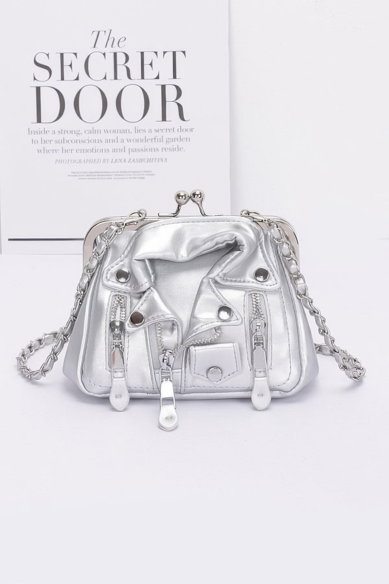 Silver faux leather crossbody bag with front zip details and chain strap
