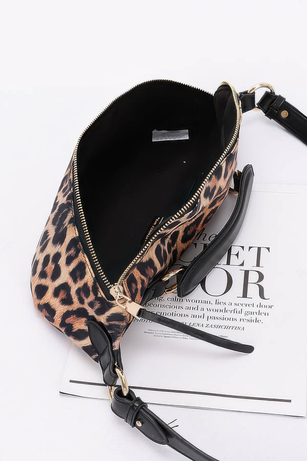 Leopard faux leather crossbody bag interior with black lining and zip opening