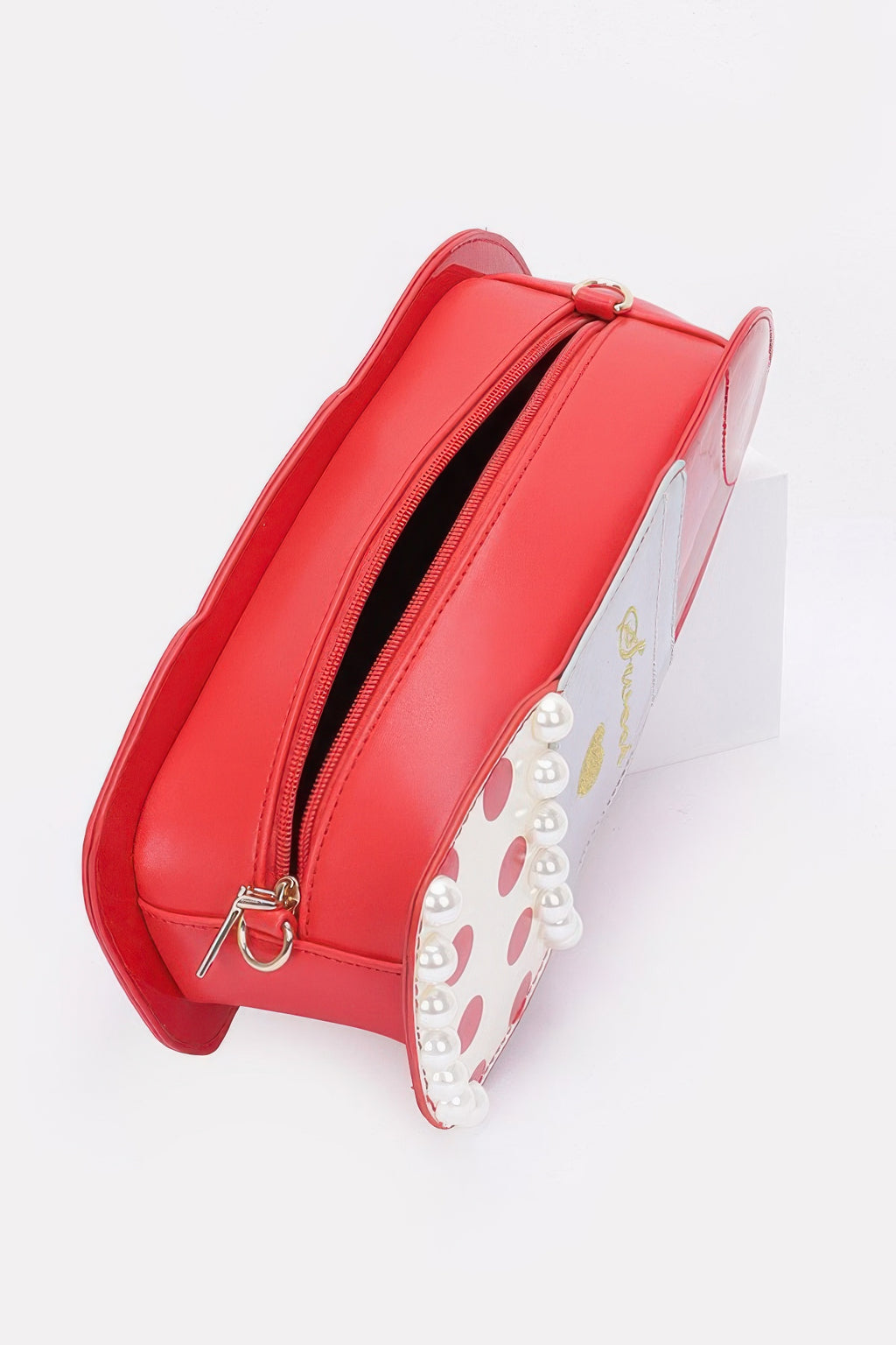Red lipstick novelty bag side view with double zippers and glossy finish