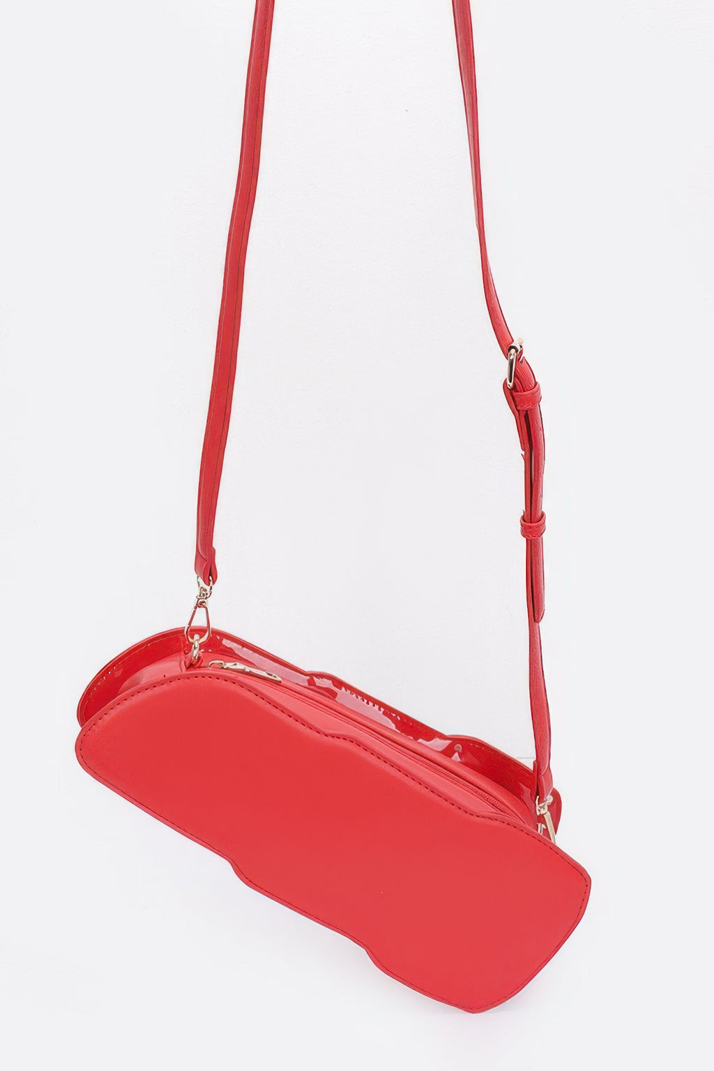 Red lipstick-shaped mini bag with long strap, curved flap, and zipper top