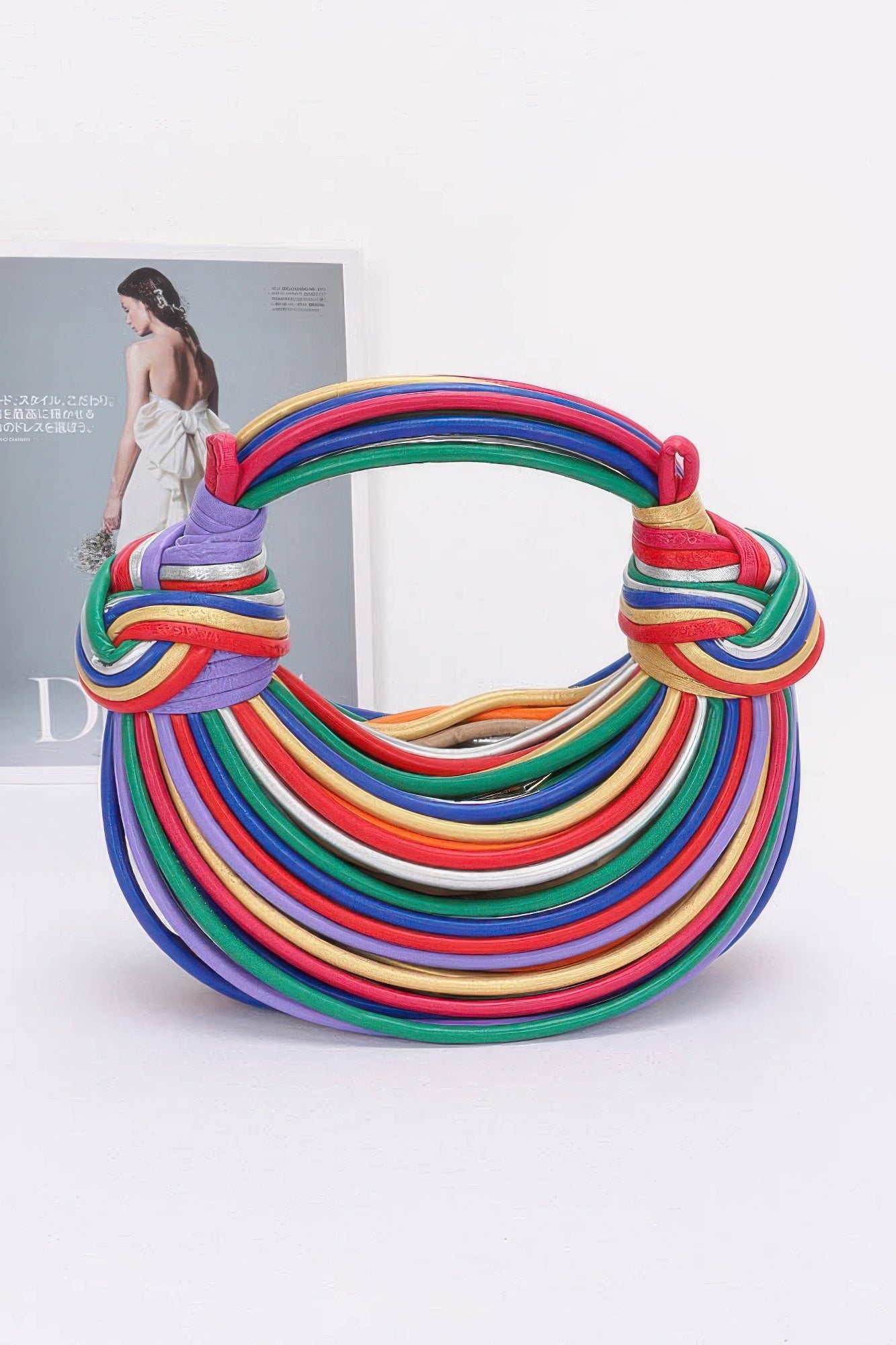 Faux leather rope hobo bag in multicolor stripes, curved top with knot handles